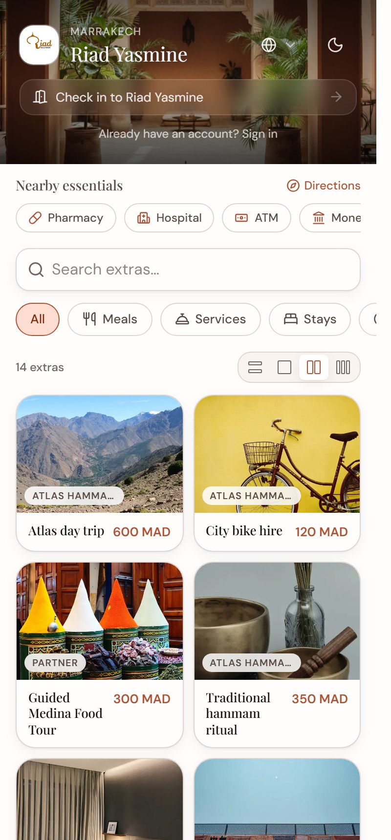 A guest storefront: check in to the property, then browse its extras with photos and prices in dirham