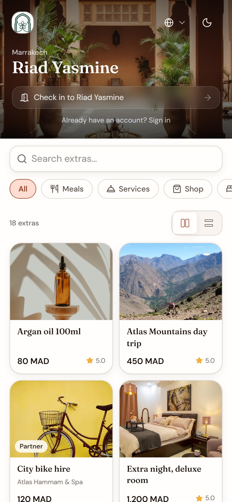 A guest storefront: check in to the property, then browse its extras with photos and prices in dirham